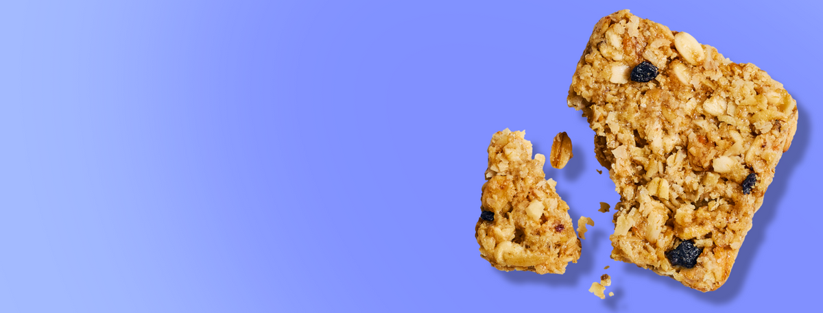 Blue background with a crunchy granola square with blueberries